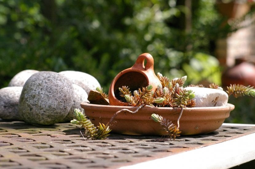 Mesa de jardín decorada con piedras y elementos naturales